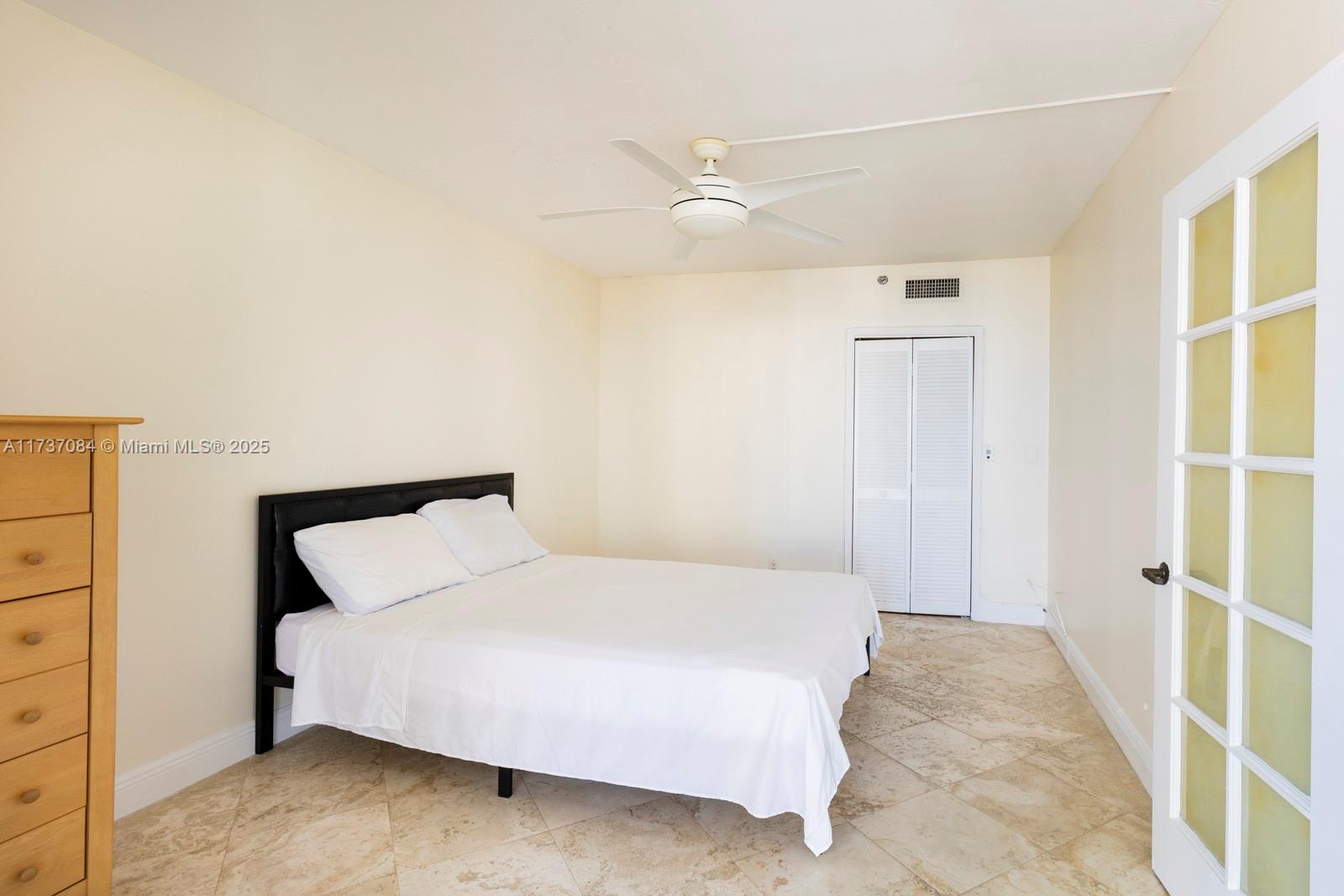 1581 Brickell Avenue, Unit 1408 Miami, FL 33129 - Photo 15 of 25 a bedroom with a bed and a window