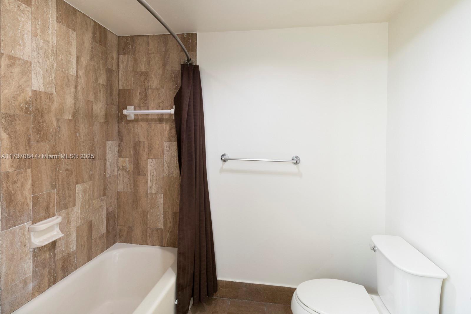 1581 Brickell Avenue, Unit 1408 Miami, FL 33129 - Photo 18 of 25 a bathroom with a shower and a toilet