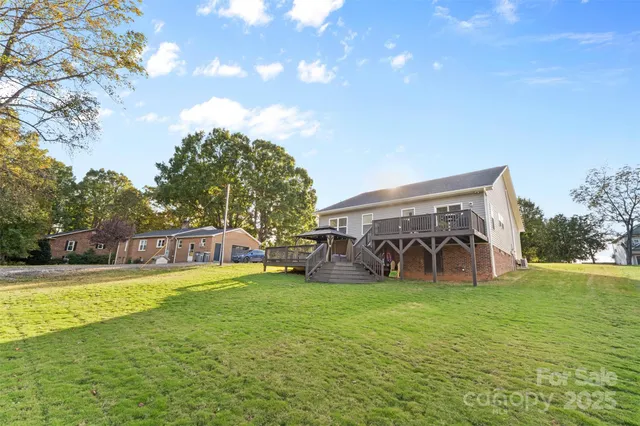a view of a house with yard and sitting area