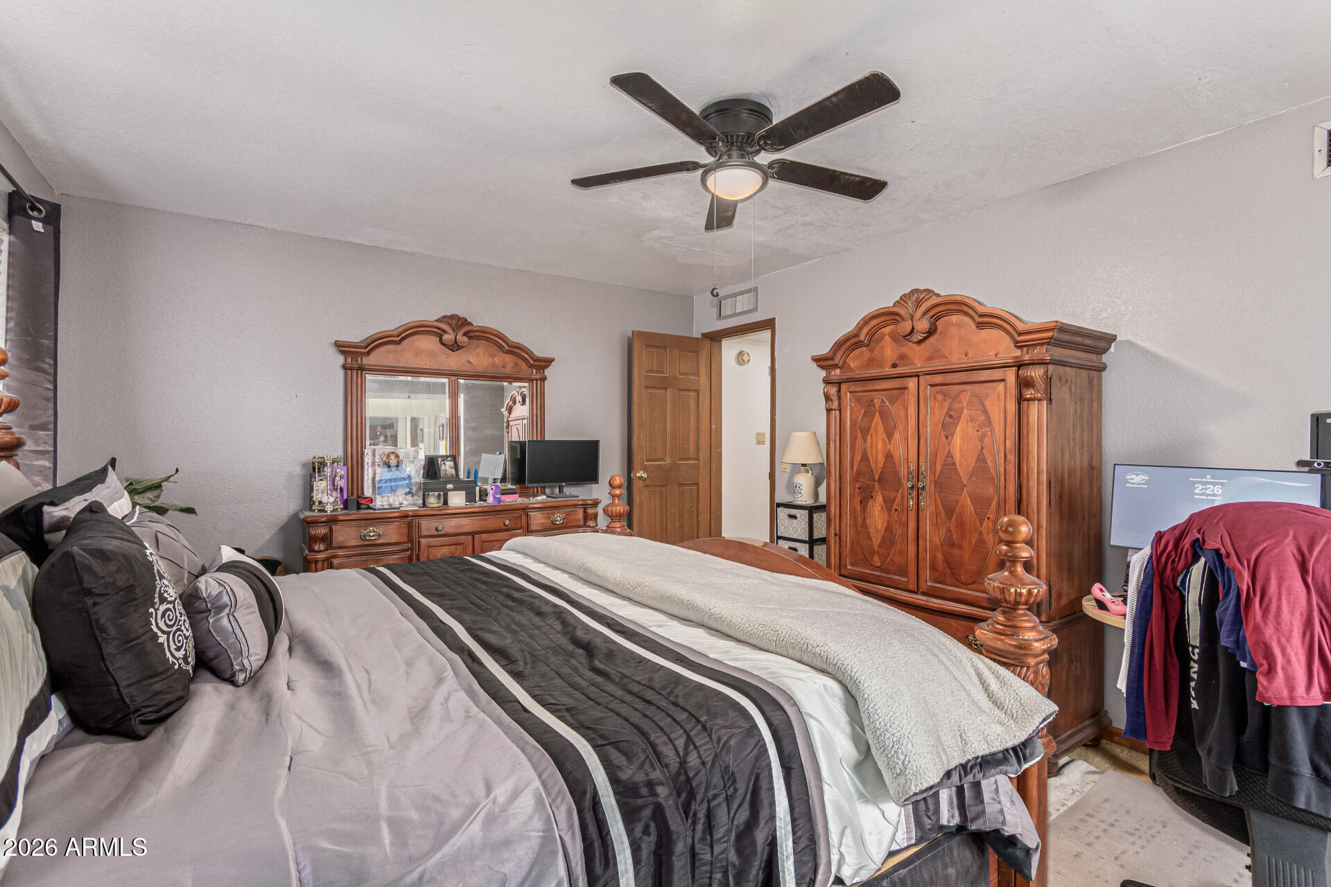 21613 South 154th Street Gilbert, AZ 85298 - Photo 17 of 57 a bedroom with a bed a closet and flat tv screen
