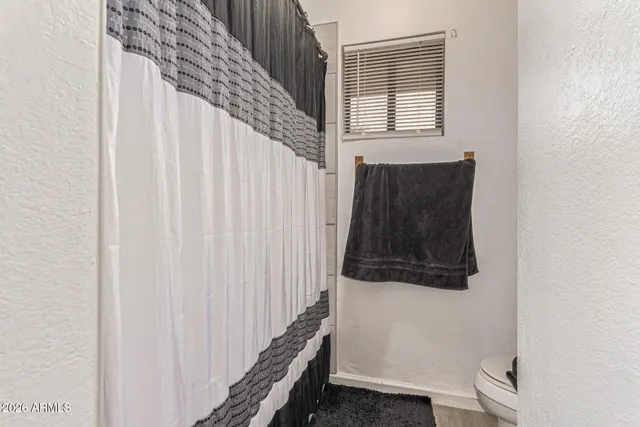 a kitchen with kitchen island a dining table chairs refrigerator and cabinets