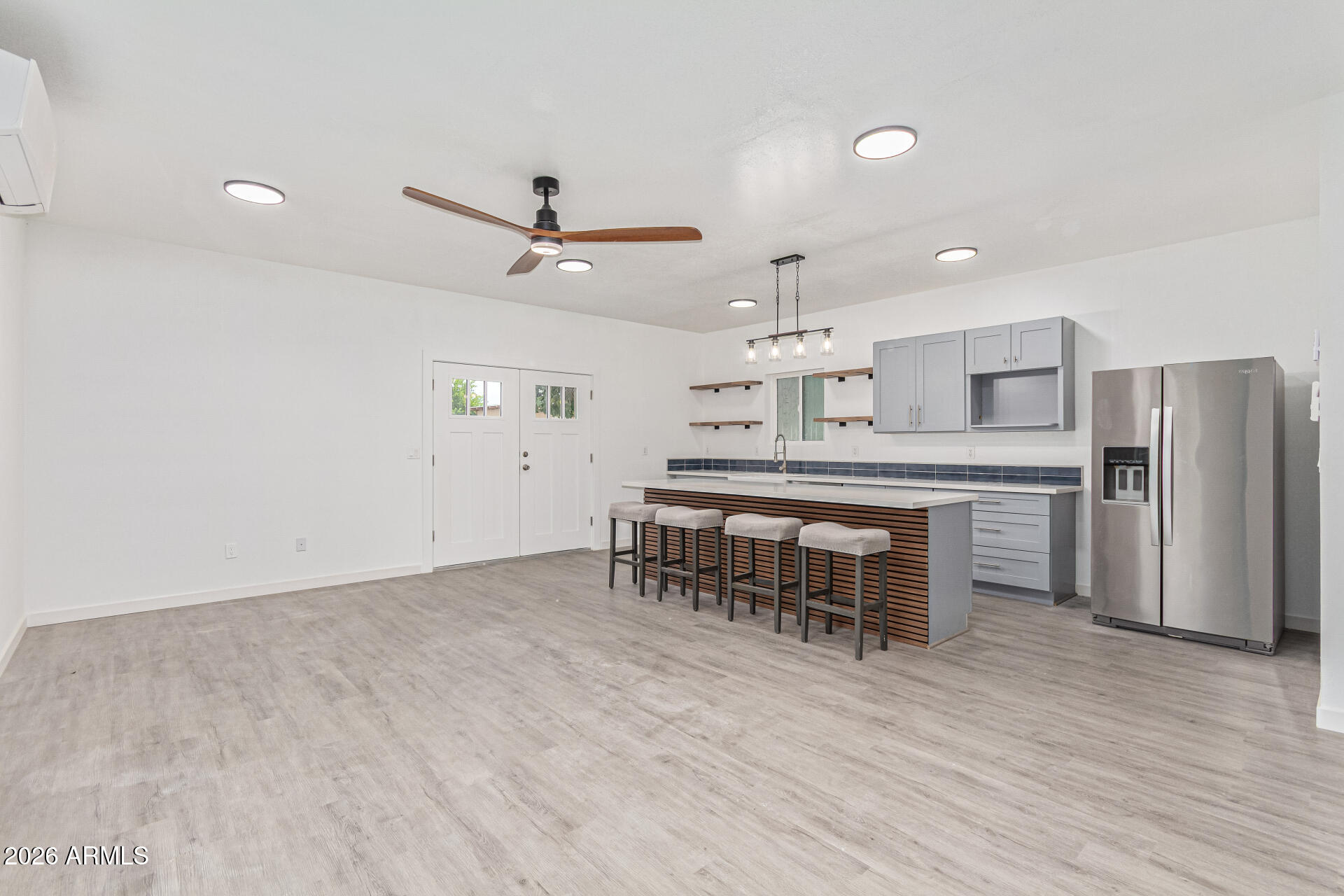21613 South 154th Street Gilbert, AZ 85298 - Photo 29 of 57 a kitchen with kitchen island a dining table chairs refrigerator and cabinets