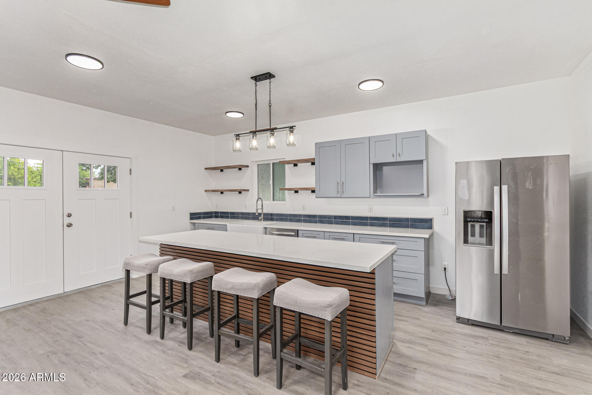 21613 South 154th Street Gilbert, AZ 85298 - Photo 33 of 57 a kitchen with stainless steel appliances a dining table chairs and wooden floor