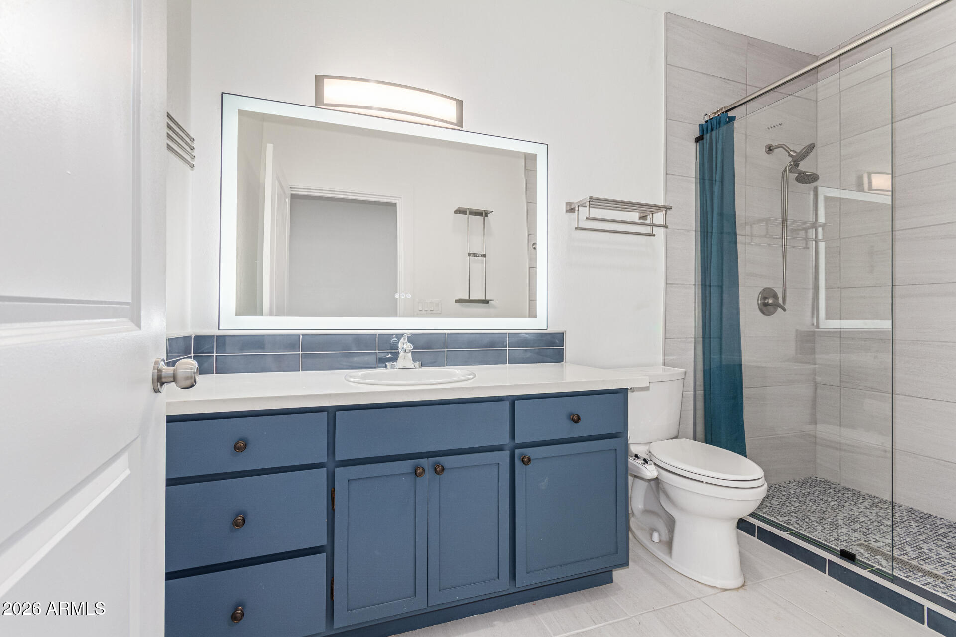 21613 South 154th Street Gilbert, AZ 85298 - Photo 35 of 57 a bathroom with a toilet a sink a light fixture and a mirror