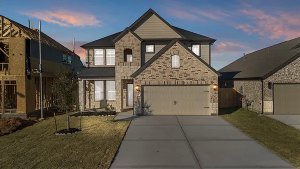 a front view of a house with garage