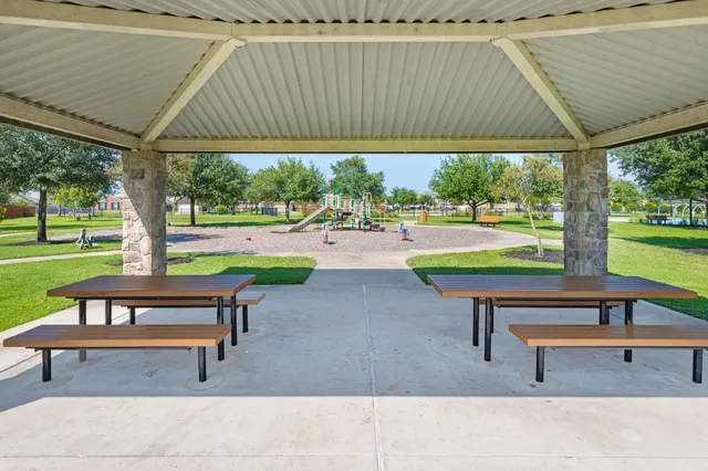a backyard of a house with table and chairs