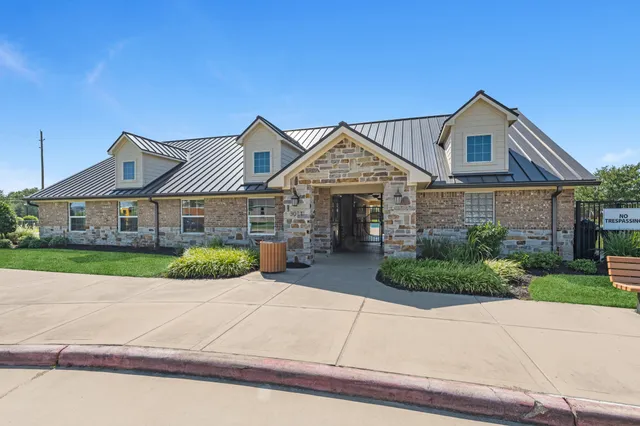 a front view of a house with a yard and potted plants