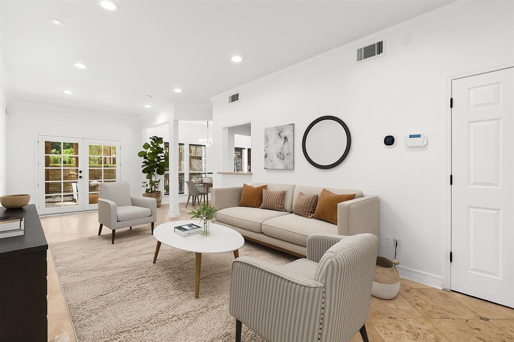 a living room with furniture a rug and a large window