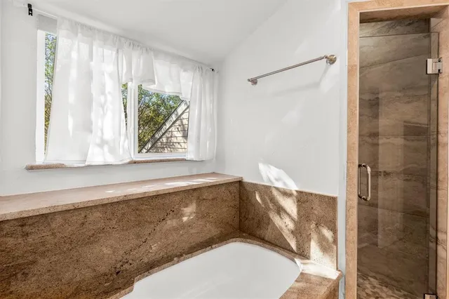 a bathroom with a bathtub and window