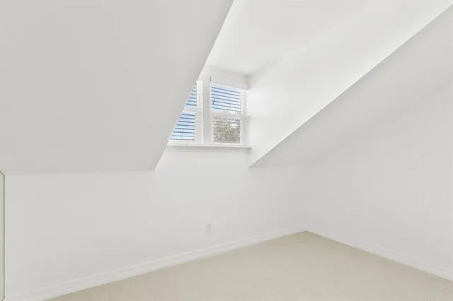 a view of a small space with wooden floor and a window