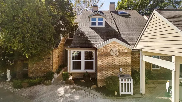 a view of a brick house with large windows