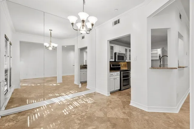 a view of a kitchen with refrigerator and cabinets