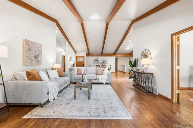a living room with furniture large window and a fireplace