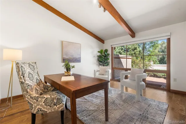 a bedroom with a bed and large window