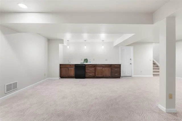 a room with a dresser and a potted plant