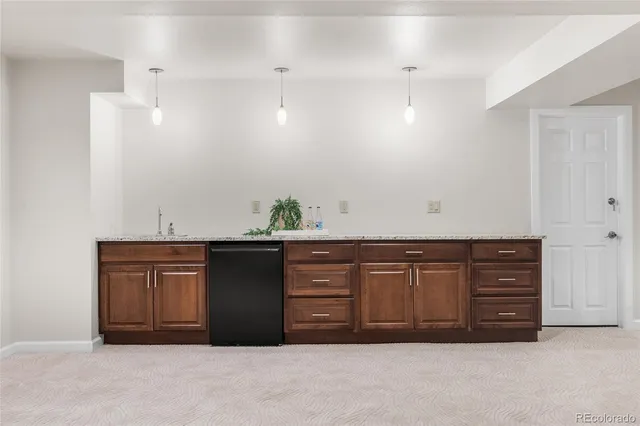 a spacious bathroom with a granite countertop sink a toilet and a mirror