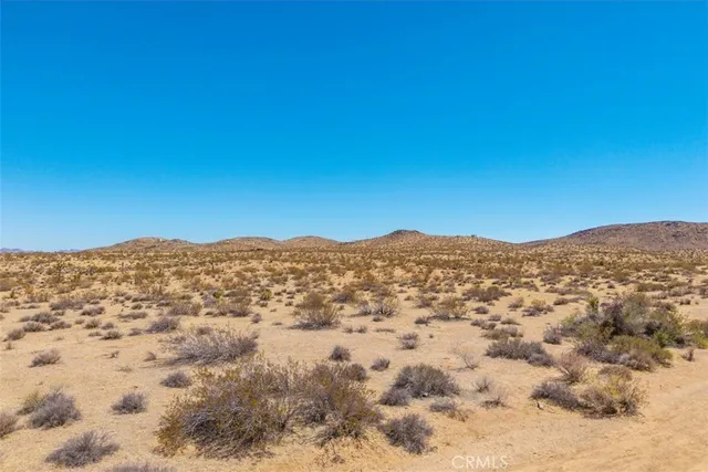 a view of a mountain range in a cloudy sky