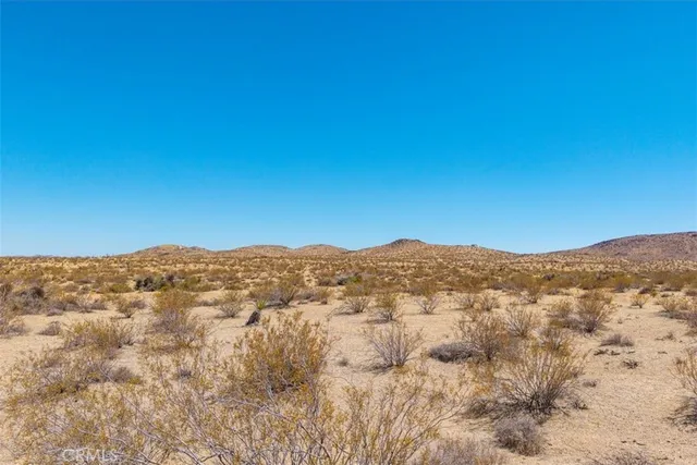 a view of a mountain range in a cloudy sky