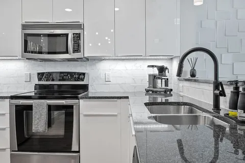 a kitchen with a sink and a stove top oven