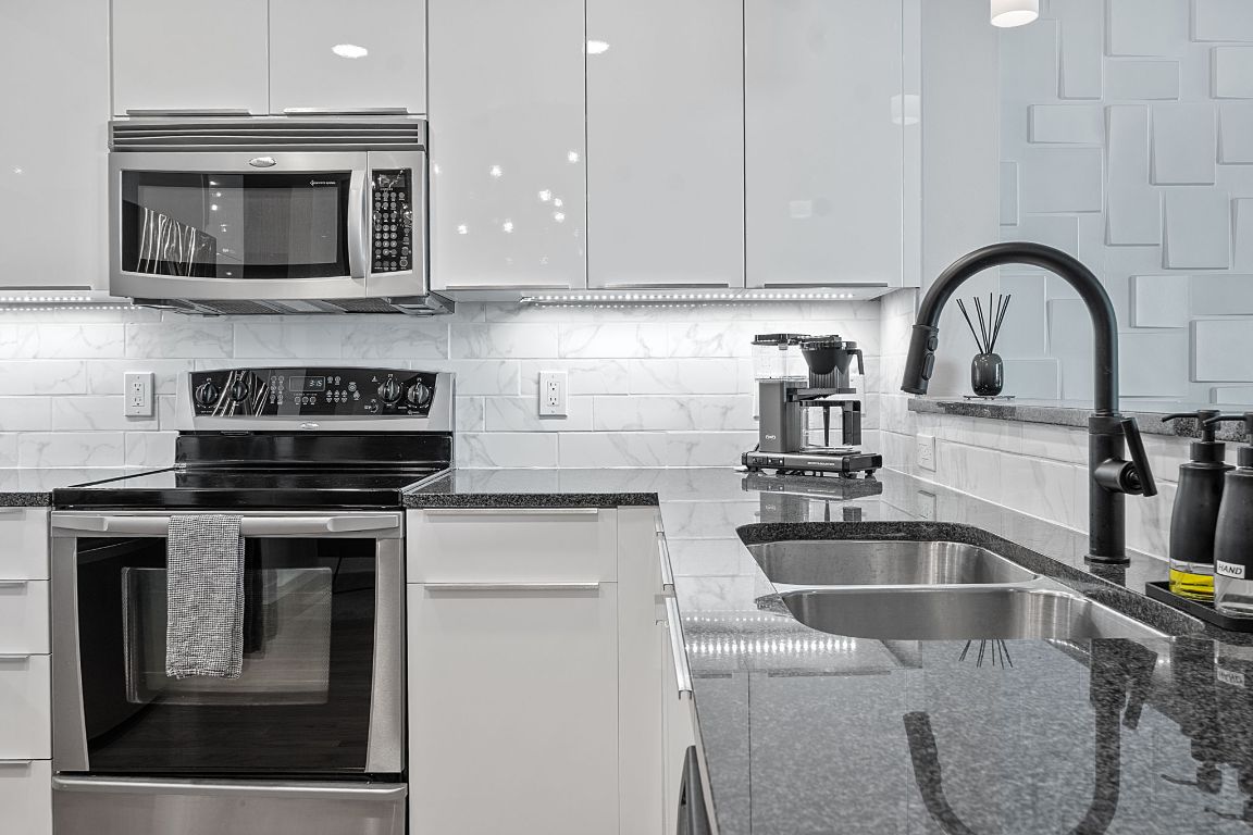 360 Nueces Street, Unit 1007 Austin, TX 78701 - Photo 11 of 40 a kitchen with a sink and a stove top oven
