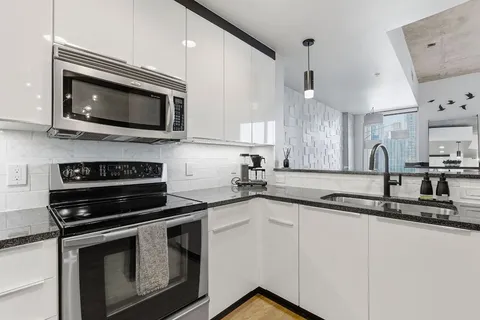 a kitchen with a sink stove and microwave