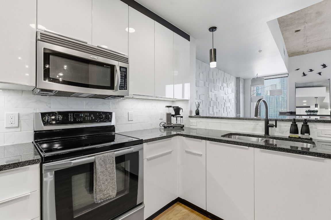 360 Nueces Street, Unit 1007 Austin, TX 78701 - Photo 12 of 40 a kitchen with a sink stove and microwave