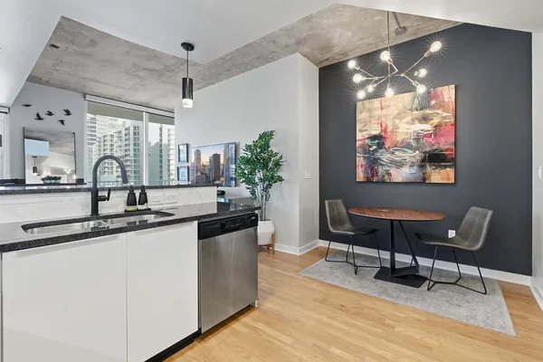 a kitchen with sink and view of living room