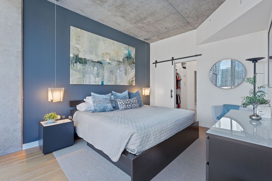 360 Nueces Street, Unit 1007 Austin, TX 78701 - Photo 19 of 40 a bedroom with a bed and a painting on the wall