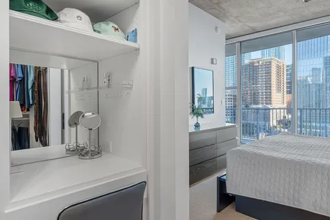 a room with a bed and a mirror