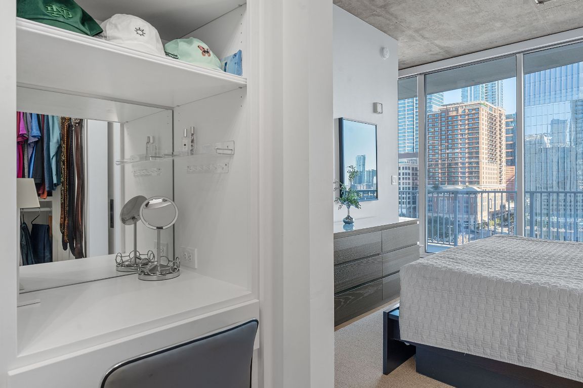 360 Nueces Street, Unit 1007 Austin, TX 78701 - Photo 20 of 40 Bedroom with access to exterior, a wall of windows, and a city view
