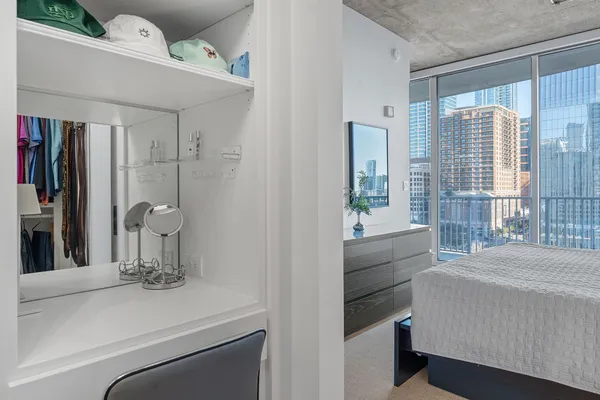 a room with a bed and a mirror