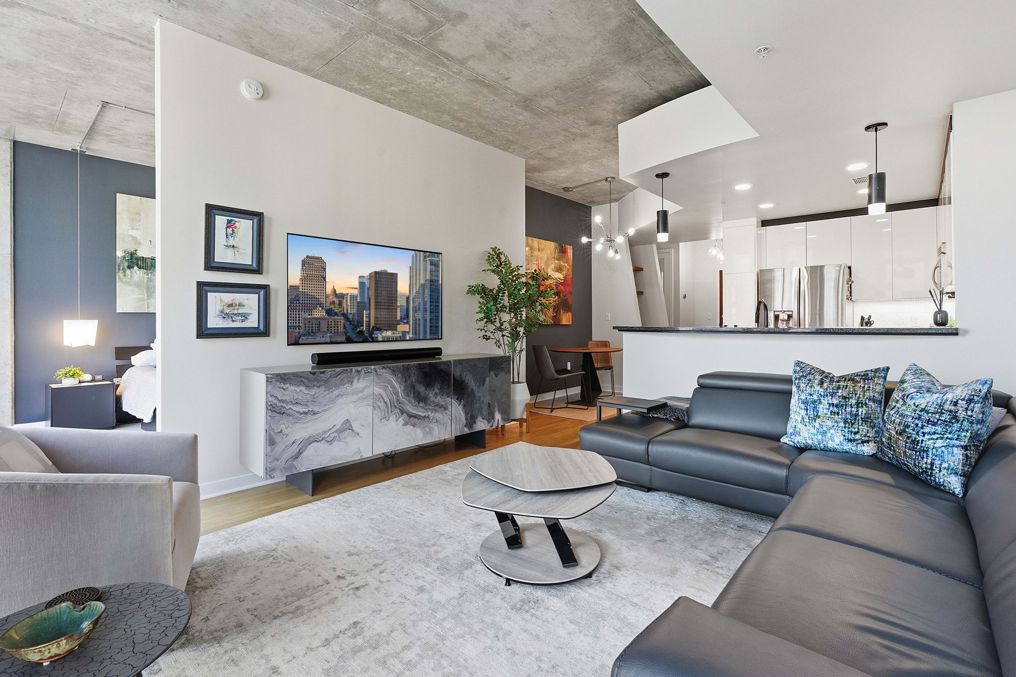 360 Nueces Street, Unit 1007 Austin, TX 78701 - Photo 2 of 40 Living room with light wood-type flooring and a chandelier