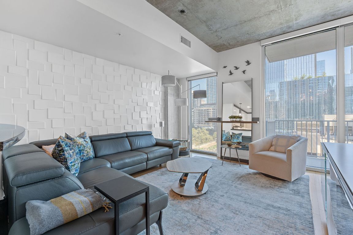 360 Nueces Street, Unit 1007 Austin, TX 78701 - Photo 2 of 40 Living room with wood finished floors, expansive windows, and a view of city