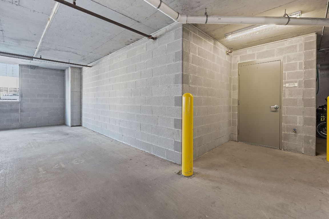 360 Nueces Street, Unit 1007 Austin, TX 78701 - Photo 30 of 40 Garage with concrete block wall