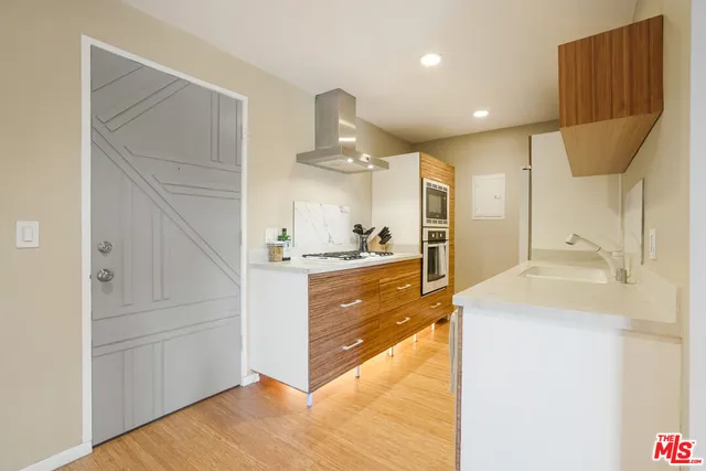 a view of a kitchen with a sink and refrigerator