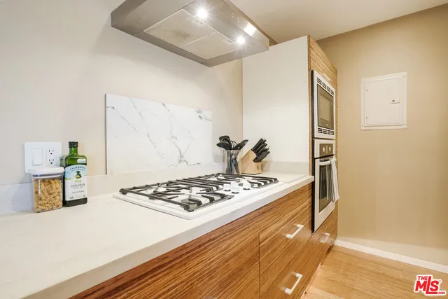 a kitchen with stainless steel appliances granite countertop a stove and a refrigerator
