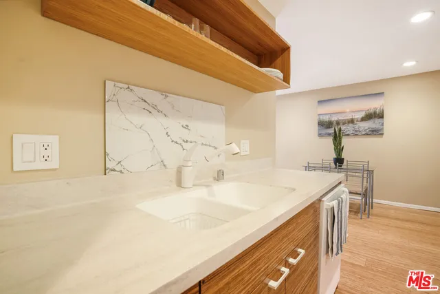 a spacious bathroom with a sink and a mirror