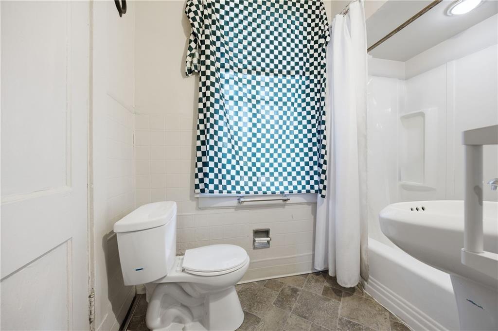 1712 Termon Avenue Pittsburgh, PA 15212 - Photo 21 of 38 a white toilet sitting next to a bathroom sink