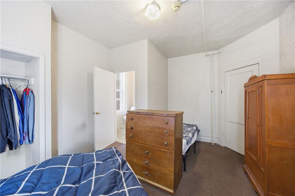 1712 Termon Avenue Pittsburgh, PA 15212 - Photo 30 of 38 a bedroom with a bed and a mirror