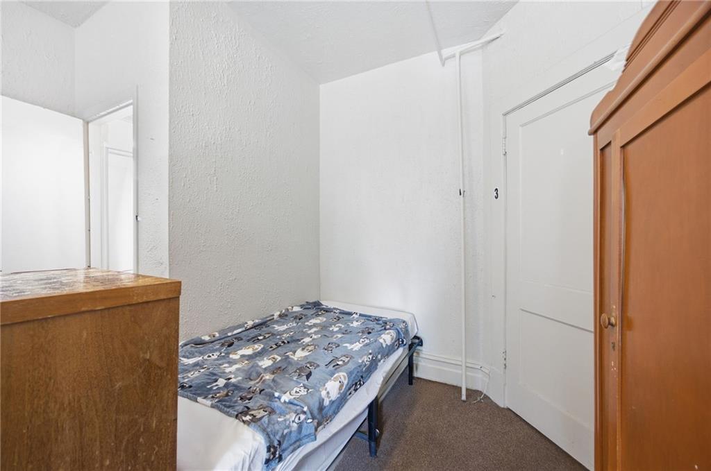 1712 Termon Avenue Pittsburgh, PA 15212 - Photo 32 of 38 a bedroom with a bed and a window