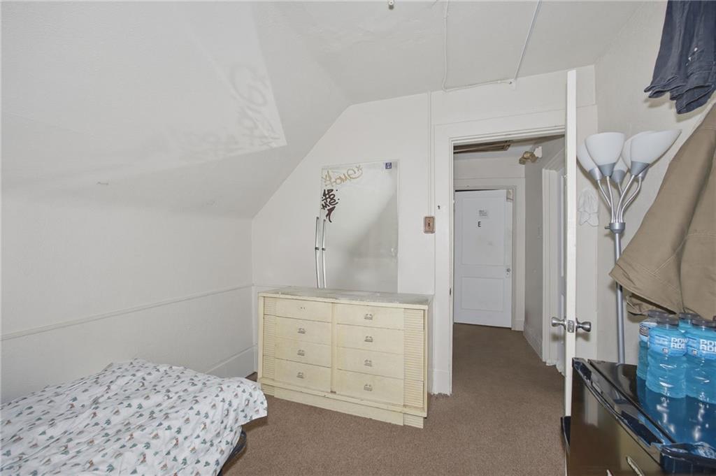 1712 Termon Avenue Pittsburgh, PA 15212 - Photo 34 of 38 a bedroom with a bed and a dresser in it