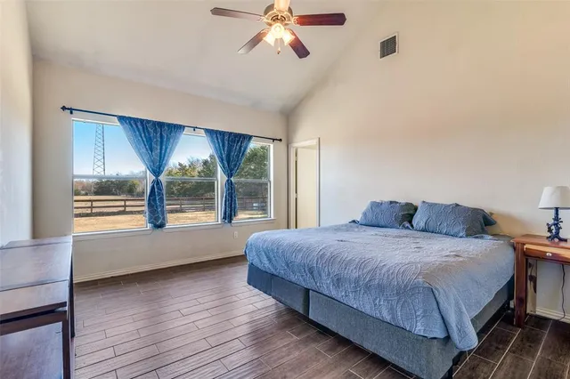 a bedroom with a large bed and a large window