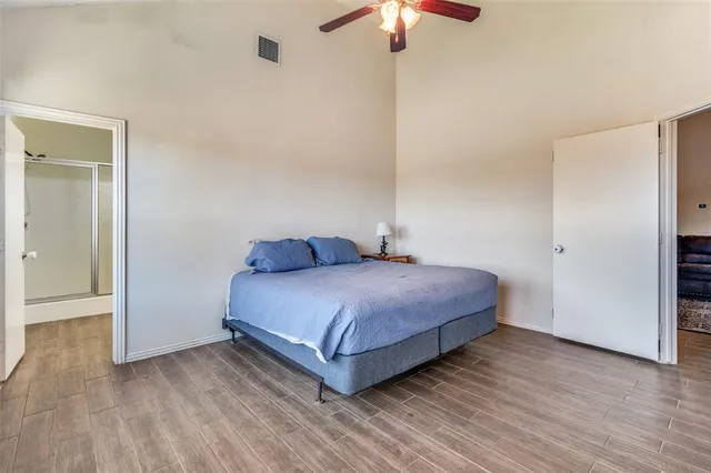 a bedroom with a bed and a chandelier