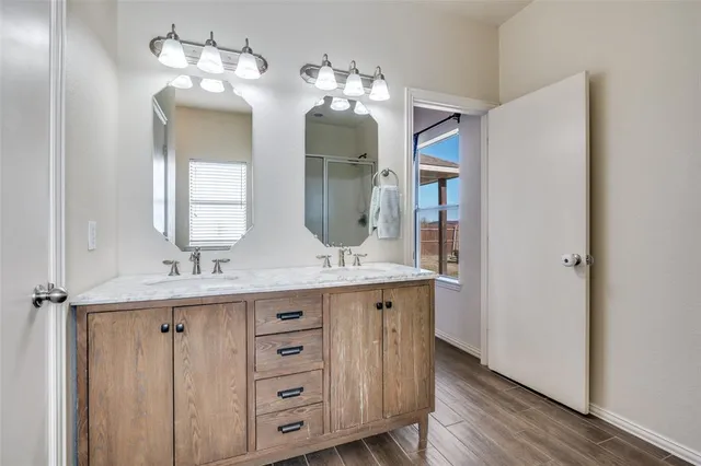 a bathroom with a double vanity sink and a mirror