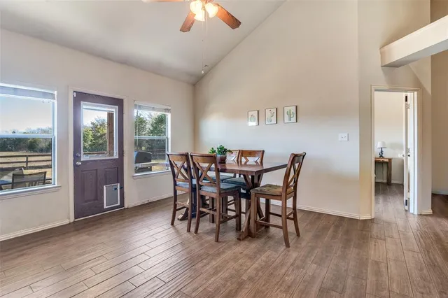 a dining room with furniture and wooden floor