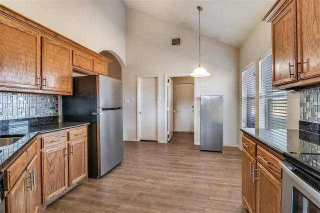 a kitchen with stainless steel appliances a refrigerator and a stove