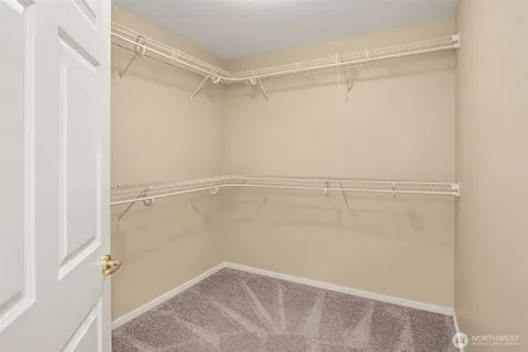 a spacious bathroom with a granite countertop sink mirror and bathtub