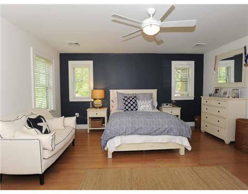3 Indian Spring Road Rowayton, CT 06853 - Photo 11 of 20 a spacious bedroom with a bed and a chandelier