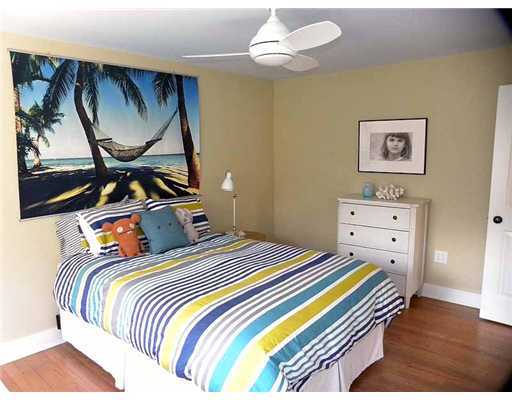 3 Indian Spring Road Rowayton, CT 06853 - Photo 18 of 20 a bedroom with a bed and a painting on the wall