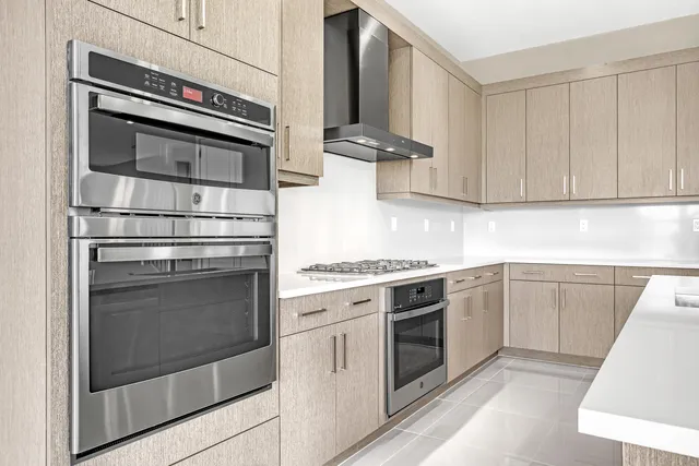 a kitchen with cabinets and stainless steel appliances